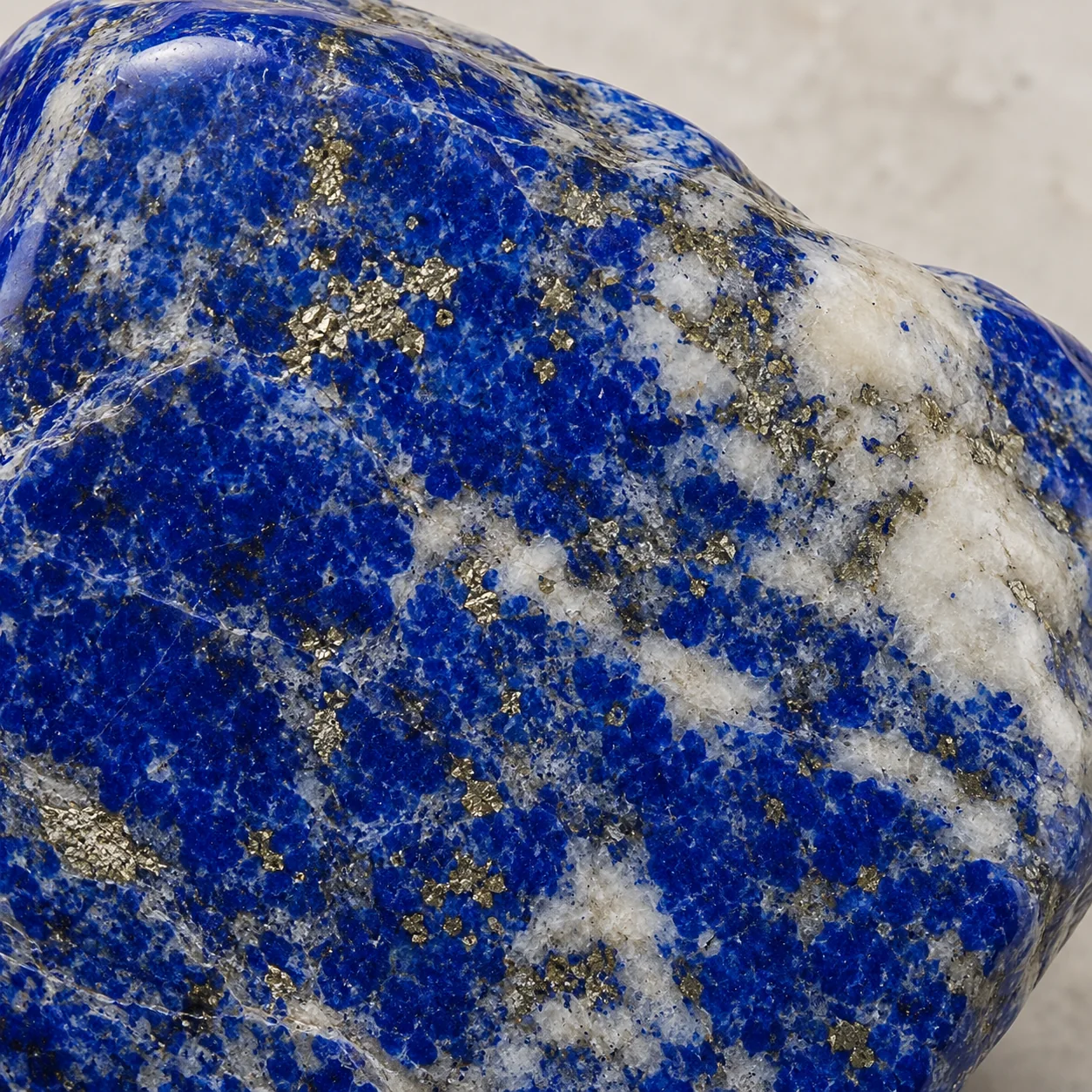 Generated macro view of polished lapis lazuli showing blue lazurite, pyrite and calcite