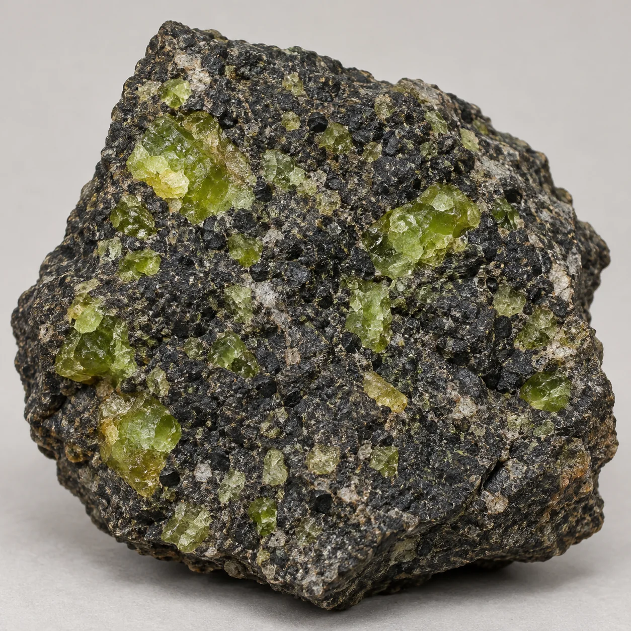 Generated matrix view of green olivine/peridot grains in a dark mantle-rock matrix